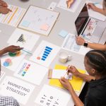 Overhead shot of diverse team analyzing marketing strategies with charts and graphs. — Deciding on the Most Effective SEO Out