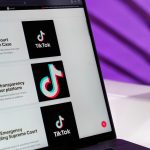 Close-up of laptop screen showing TikTok news articles with a purple background. — Enhance Your Influence: The Strategic Adva