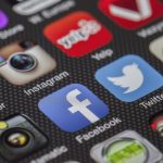 Close-up image of various social media app icons on a smartphone screen. — Enterprise Application Management - Phases, Compon