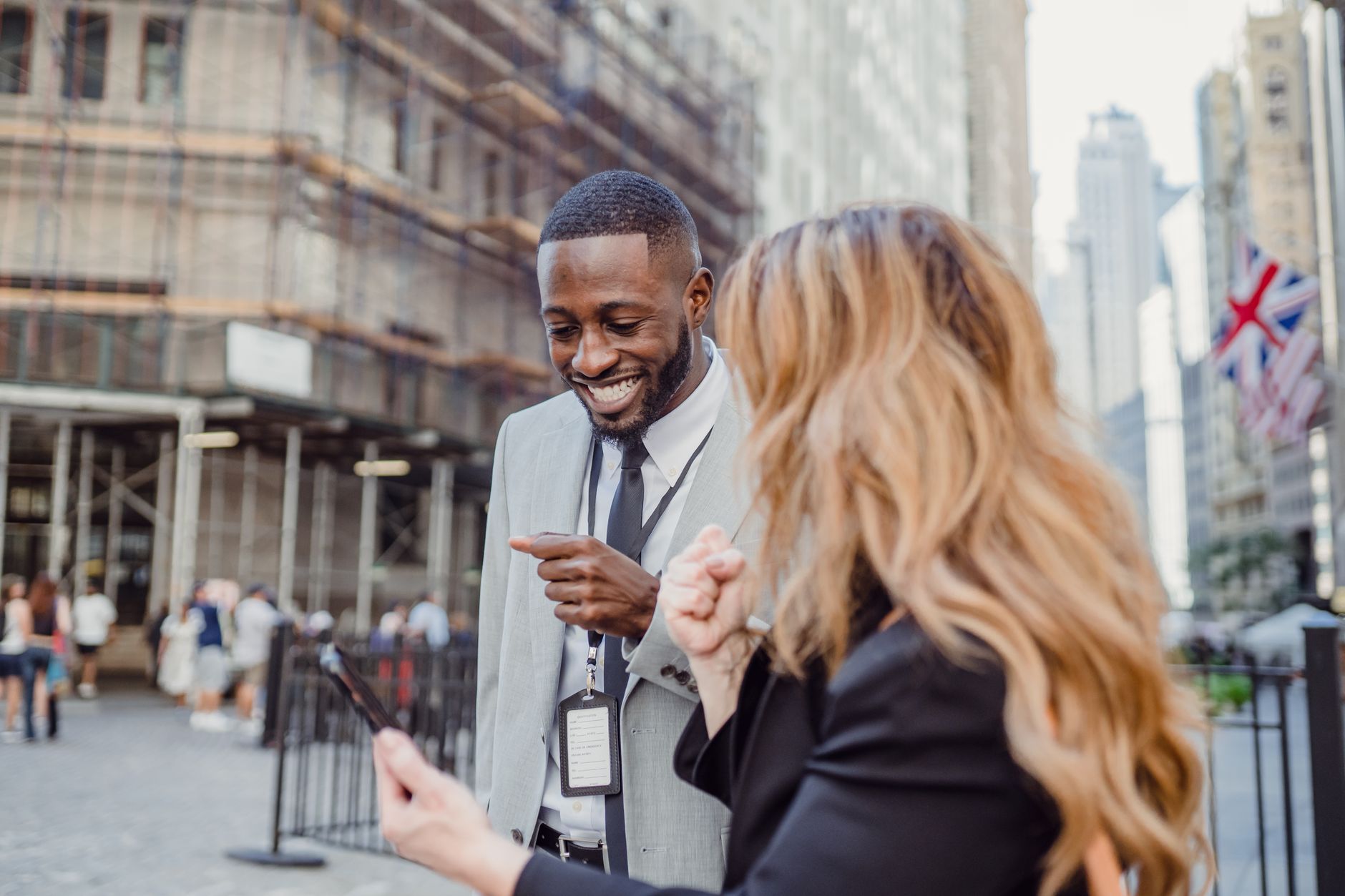 Two business professionals engage in lively conversation on an urban street, sharing insights. — Generate Genuine Interest wi