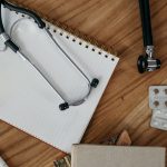 Flat lay of medical tools and supplies on a wooden desk surface. — How Do I Get TRT? Understand Required Tests and Timeline