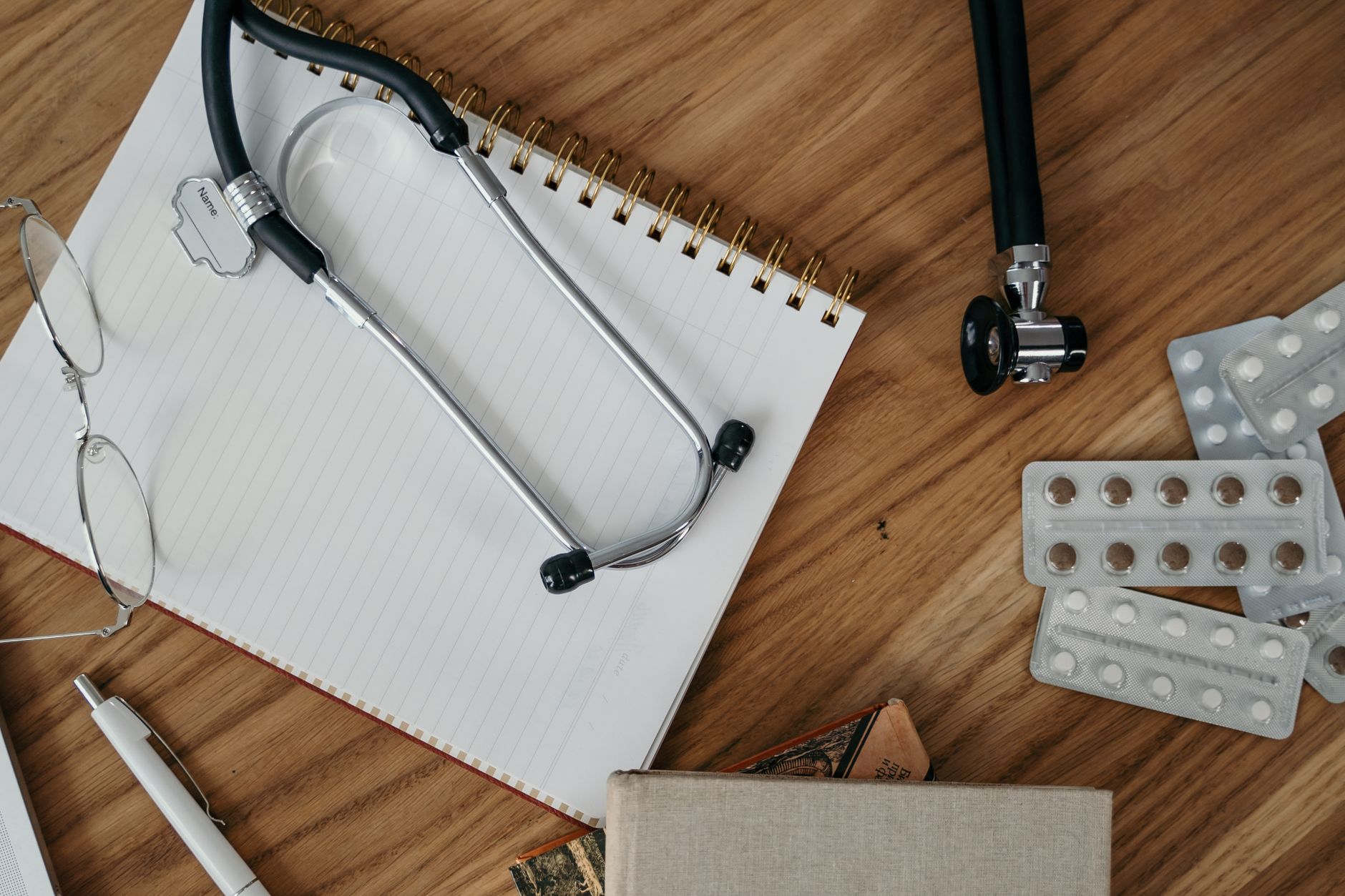 Flat lay of medical tools and supplies on a wooden desk surface. — How Do I Get TRT? Understand Required Tests and Timeline