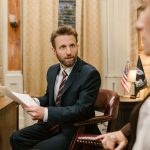 Businessman in suit discussing legal documents in office environment. — How Patent Licensing Can Boost Your Revenue and Innov