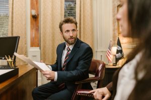 Businessman in suit discussing legal documents in office environment. — How Patent Licensing Can Boost Your Revenue and Innov