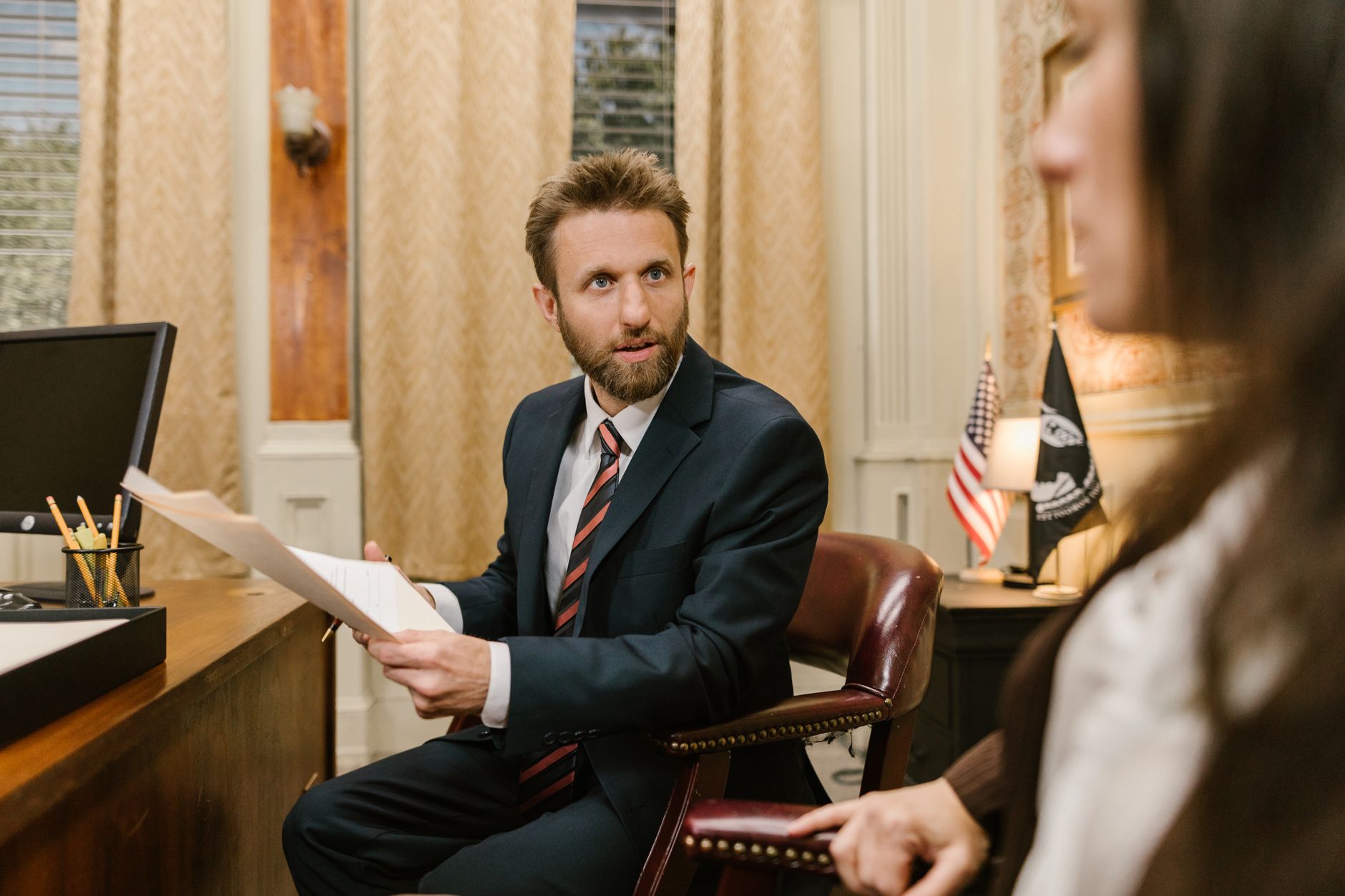 Businessman in suit discussing legal documents in office environment. — How Patent Licensing Can Boost Your Revenue and Innov