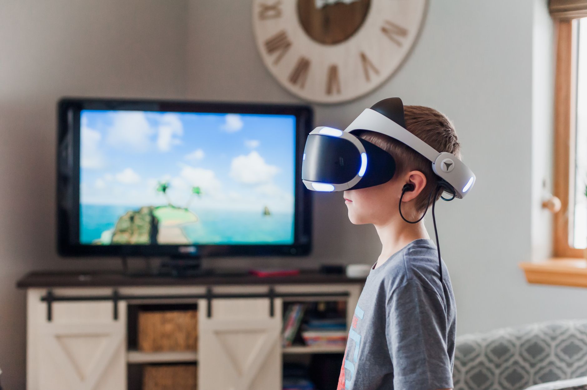 A young boy using a VR headset, fully engaged in a virtual reality experience indoors. — Instructions On How Change iPhone Si