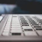 Contemporary powerful netbook keyboard with black and white keys and touchpad placed on desk — Internet Access in Jos, Platea