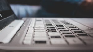 Contemporary powerful netbook keyboard with black and white keys and touchpad placed on desk — Internet Access in Jos, Platea