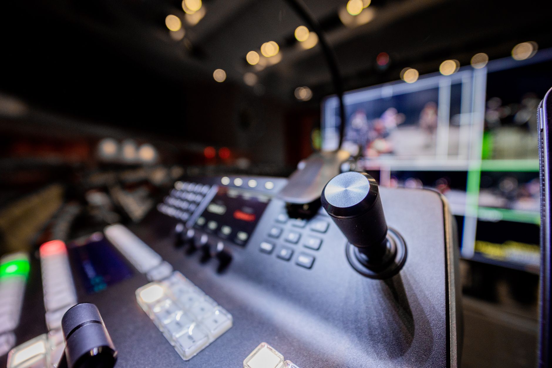 Closeup of modern professional audio console controller with buttons placed near screen in studio with lights — IP TV Offerin