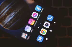 Smartphone screen showing popular social media and app icons including Facebook and Instagram. — Is Social Media Right for th