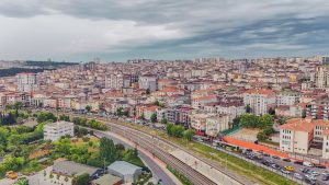 Aerial view of dense urban architecture with roads and greenery under cloudy skies. — Legitimate Sources for Purchasing a Sta