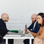 A lawyer consulting a couple in an elegant office setting, focusing on legal matters. — Local Patent Attorneys to Help Secure