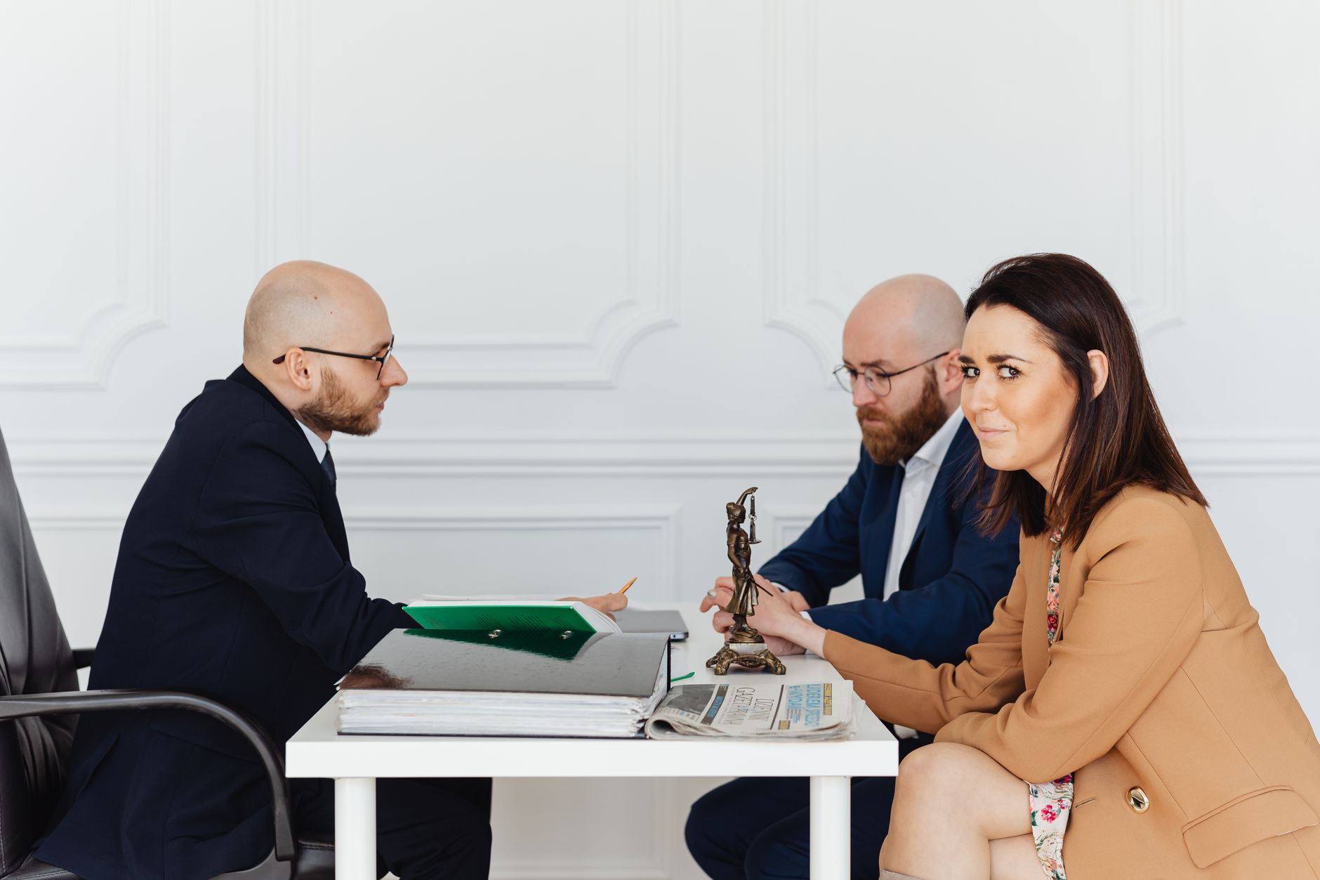 A lawyer consulting a couple in an elegant office setting, focusing on legal matters. — Local Patent Attorneys to Help Secure
