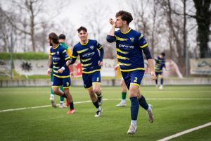 Young soccer players in blue uniforms celebrating a goal on a green field. — NBA Stream: The Best Way to Watch Live NBA Games