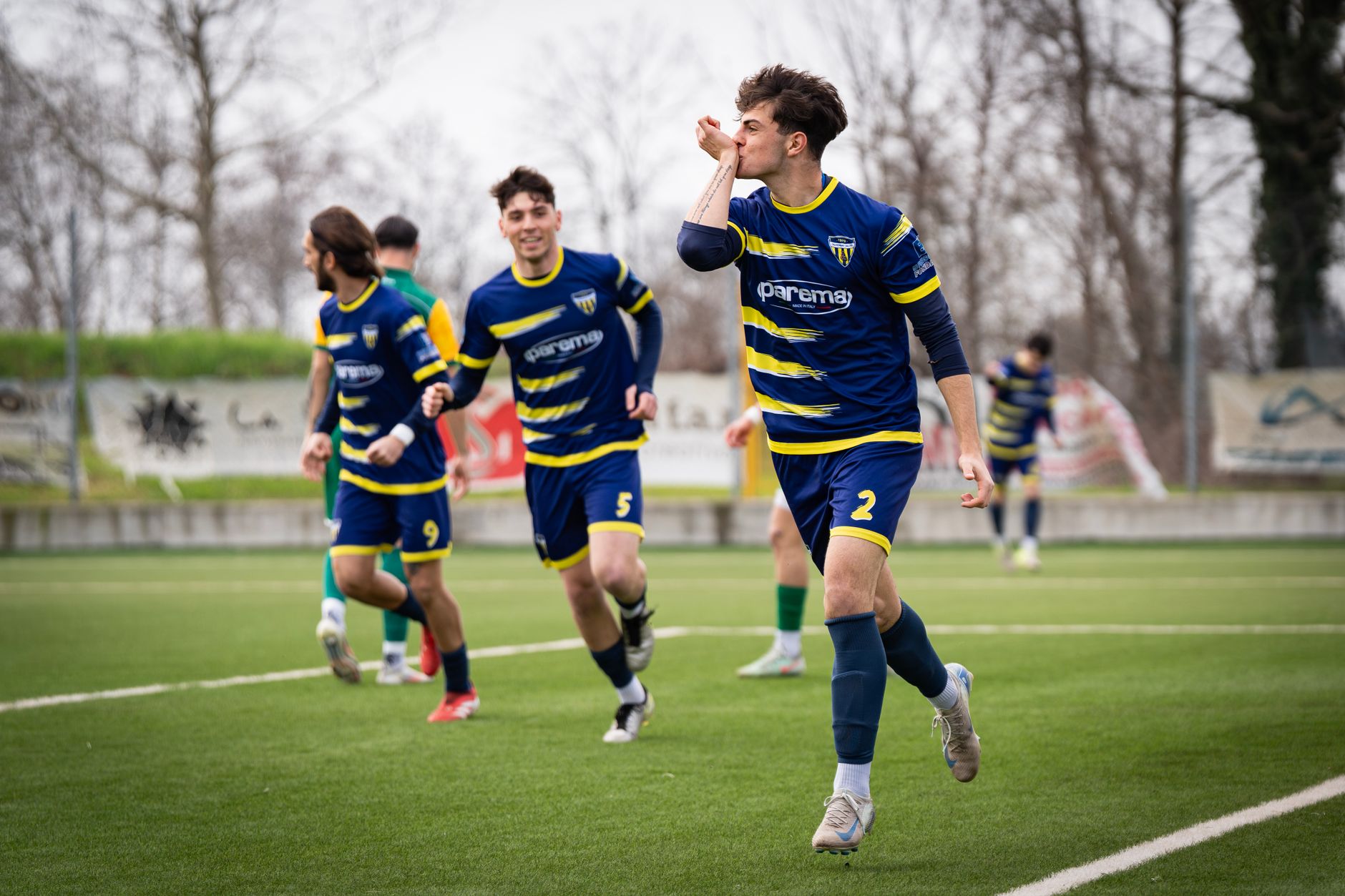 Young soccer players in blue uniforms celebrating a goal on a green field. — NBA Stream: The Best Way to Watch Live NBA Games
