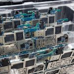 From above of circuit boards of modern smartphones placed in plastic box in electronics factory — Online Electronics Training