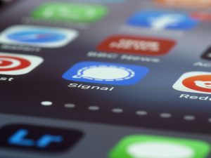 Detailed view of various app icons on a smartphone screen highlighting Signal app. — Provisional Patent Applications