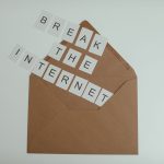 Brown envelope with tiles spelling 'Break the Internet' creates a conceptual and modern theme. — Remote Living Doesn't Mean G