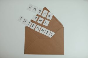 Brown envelope with tiles spelling 'Break the Internet' creates a conceptual and modern theme. — Remote Living Doesn't Mean G