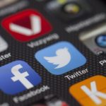 A detailed close-up of social media icons on a smartphone screen, including Facebook and Twitter. — The American Citizenship