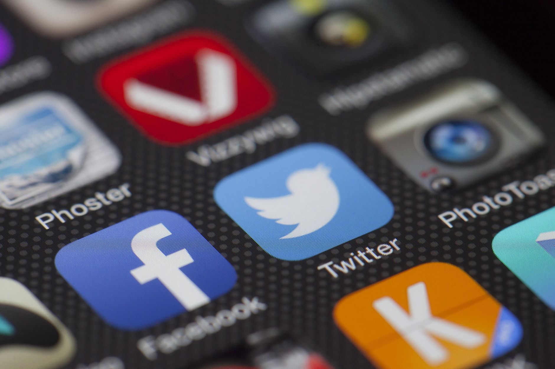 A detailed close-up of social media icons on a smartphone screen, including Facebook and Twitter. — The American Citizenship