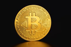 Close-up of a golden Bitcoin coin on a dark background symbolizing cryptocurrency and digital finance. — The History of 3D Te