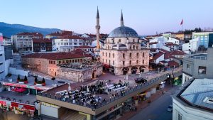 Aerial shot of Bolu city with a prominent mosque and bustling streets during twilight. — Tips And Strategy Guide To Conquer T