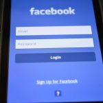 Close-up of a smartphone screen showing the Facebook login interface. — To Network and Market Using Social Media or Not to, T