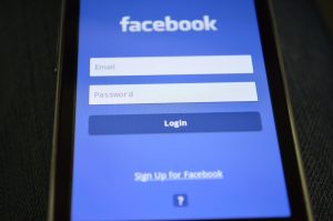 Close-up of a smartphone screen showing the Facebook login interface. — To Network and Market Using Social Media or Not to, T