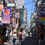 Bustling urban street in Osaka with colorful advertisements and pedestrians in daylight. — Top-Rated Canadian Online Cannabis
