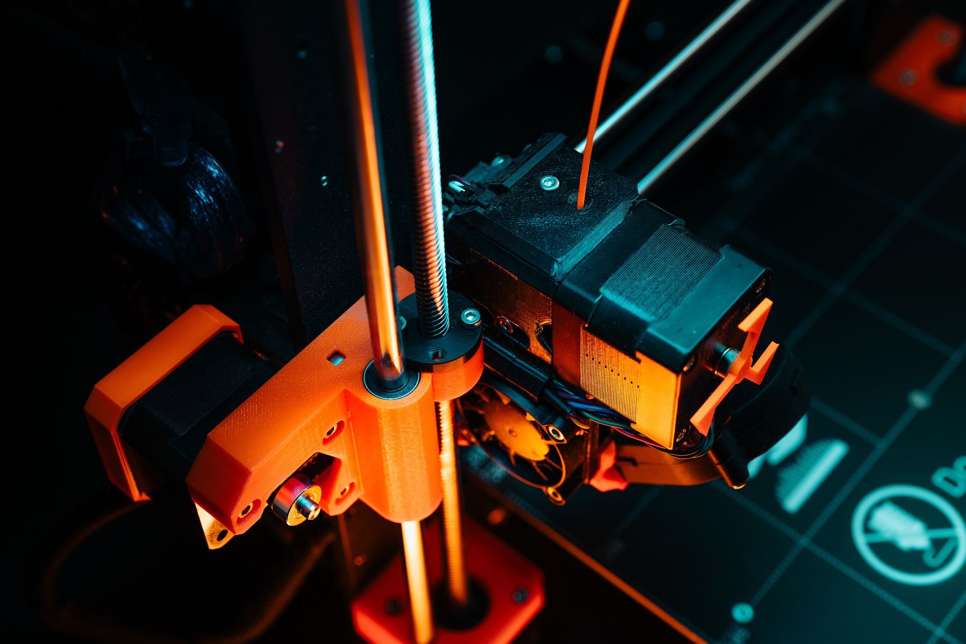 A colorful close-up of a 3D printer operating, showcasing mechanical precision and technology. — Website Design and Developme