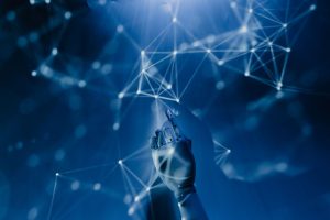 A robotic hand reaching into a digital network on a blue background, symbolizing AI technology. — Why Buying Windsor Farms ho