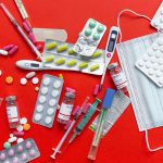 Medical supplies and medications displayed on a red background, emphasizing healthcare essentials. — Why Online Clinics Are a