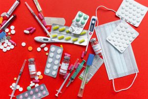 Medical supplies and medications displayed on a red background, emphasizing healthcare essentials. — Why Online Clinics Are a