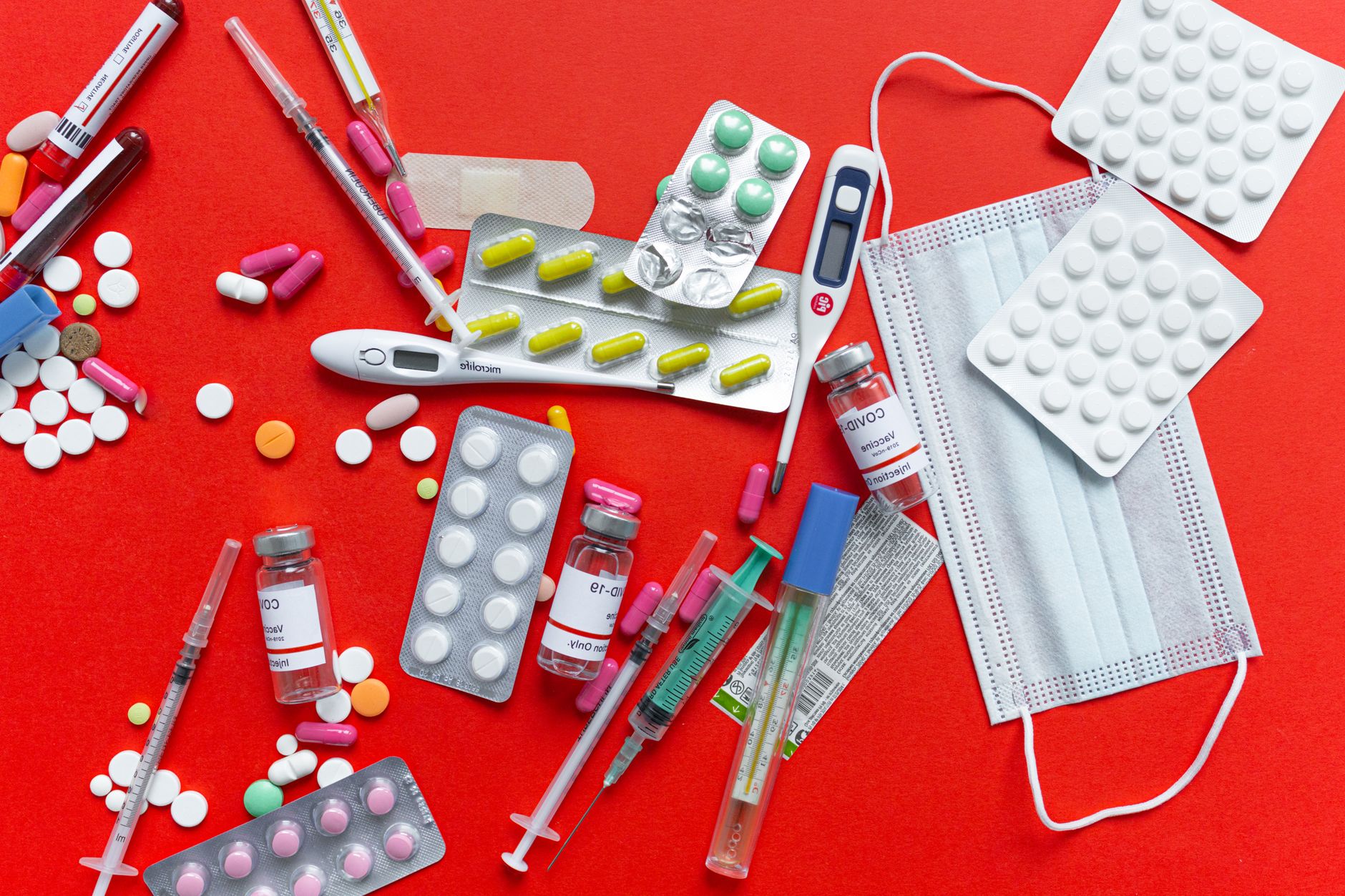 Medical supplies and medications displayed on a red background, emphasizing healthcare essentials. — Why Online Clinics Are a